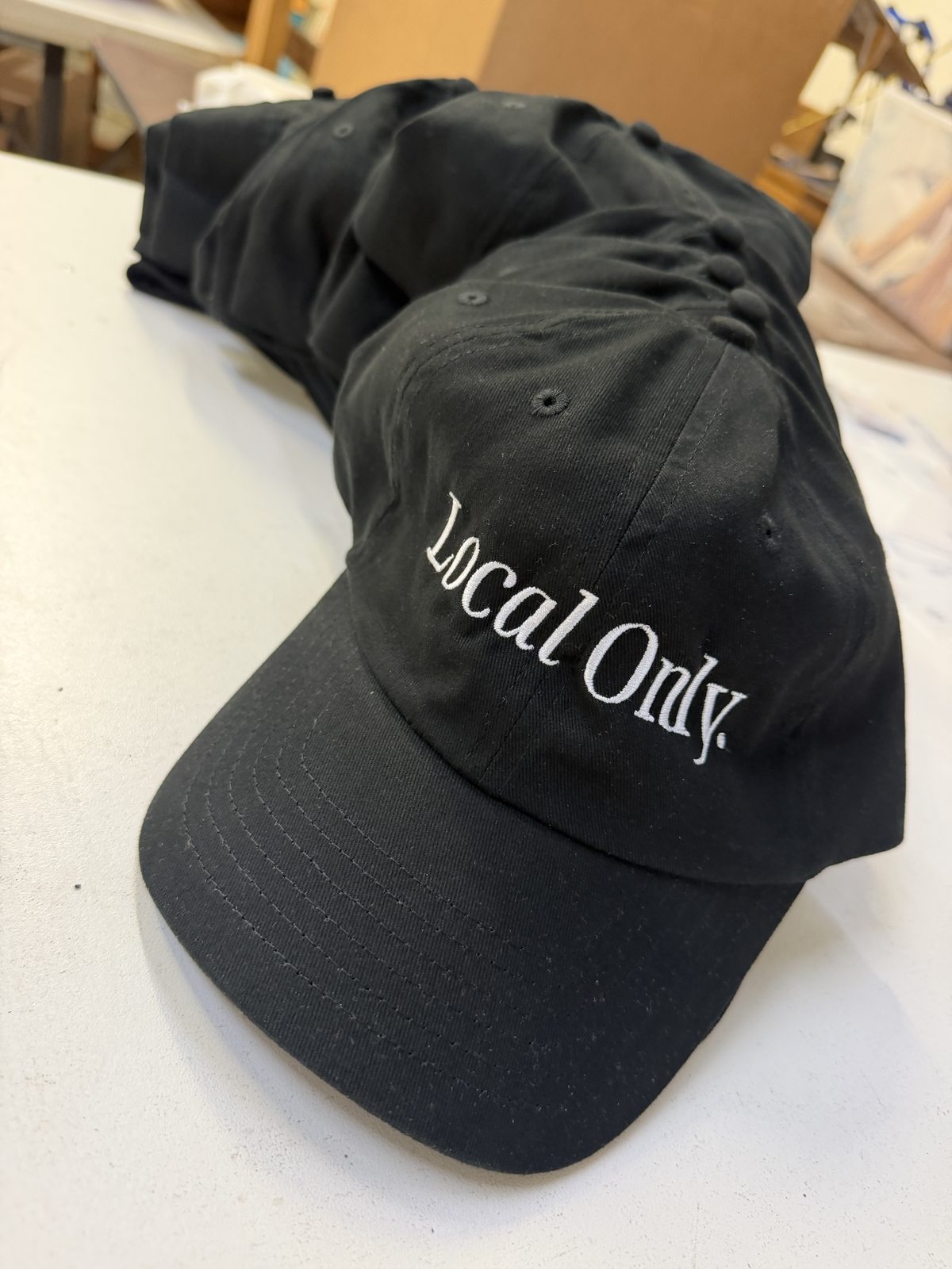 Black caps with white embroidered Local Only lettering
